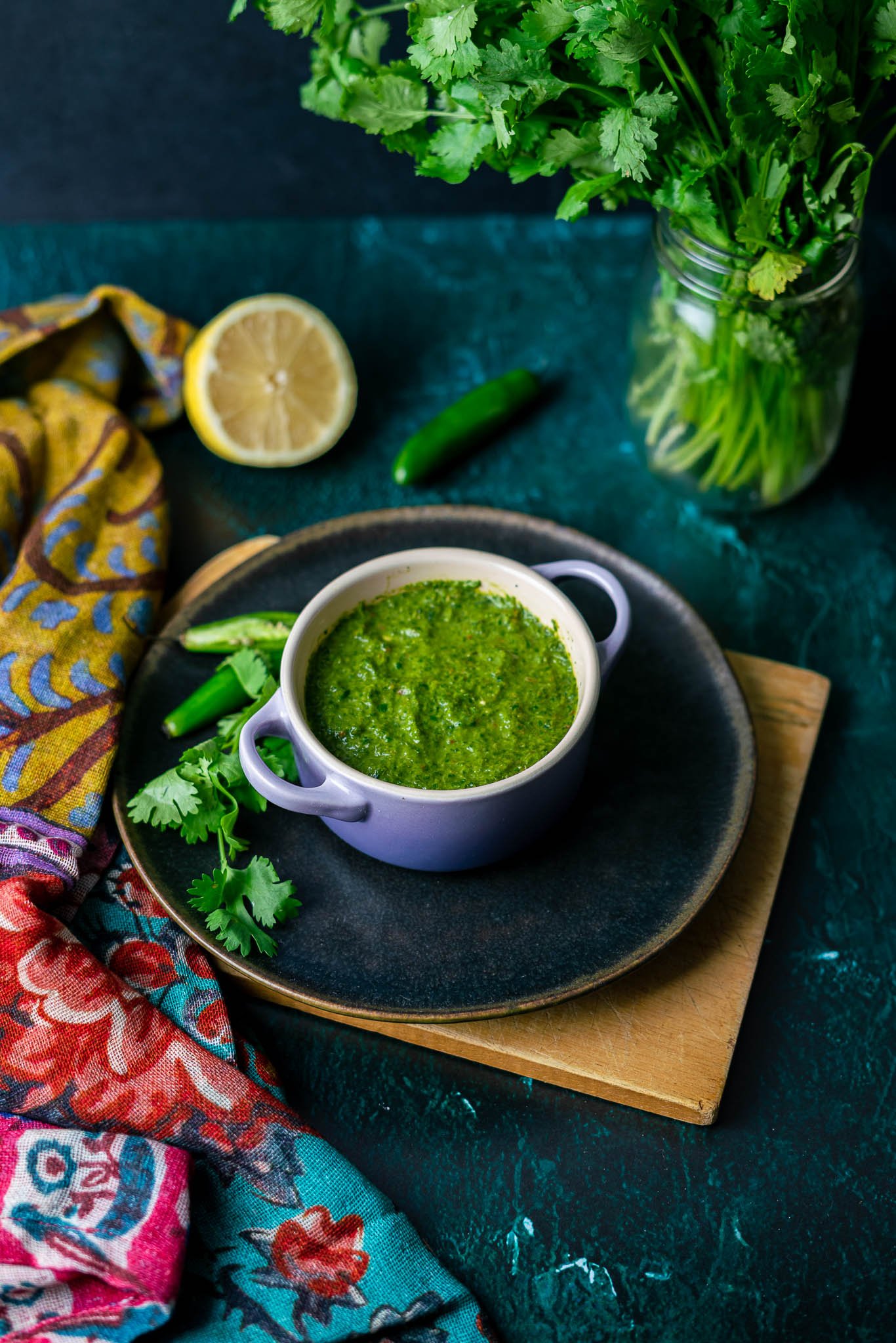 Cilantro Mint Chutney in Le Creuset Cocette with CIlantro and Serrano Peppers and Half a Lemon with Cilantro