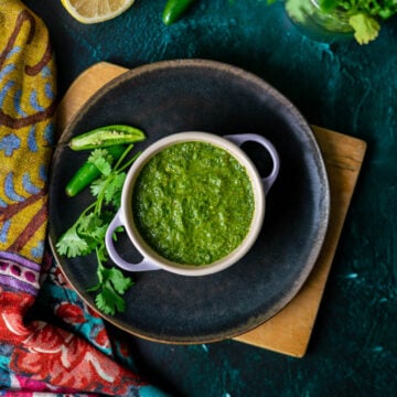 Cilantro Mint Chutney Overhead in Le Creuset Cocette with CIlantro and Serrano Peppers and Half a Lemon with Cilantro