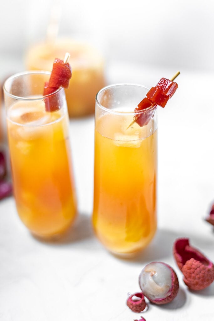 Two Guava Sangrias in Fluted Glasses with Lychees and Guava Paste Garnish