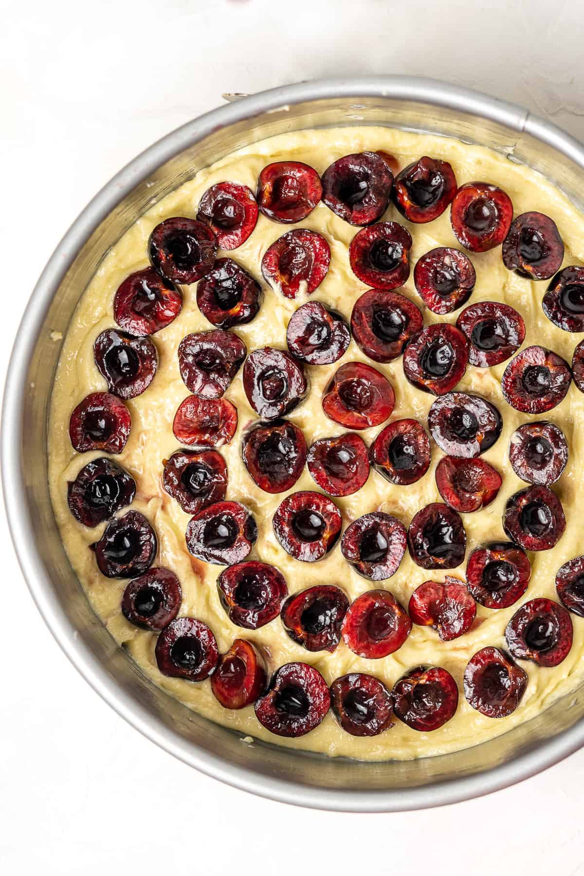 Unbaked cherry almond cake with layer of cherries