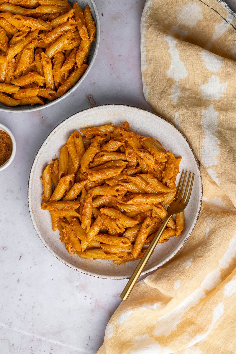 two bowls of butter masala pasta with  a small bowl of makhani spices