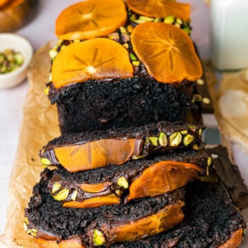 Four Persimmon Chocolate Loaf Cake Slices with milk, persimmon slices, and pistachios