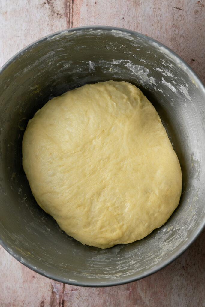 smooth brioche dough in bowl before proofing