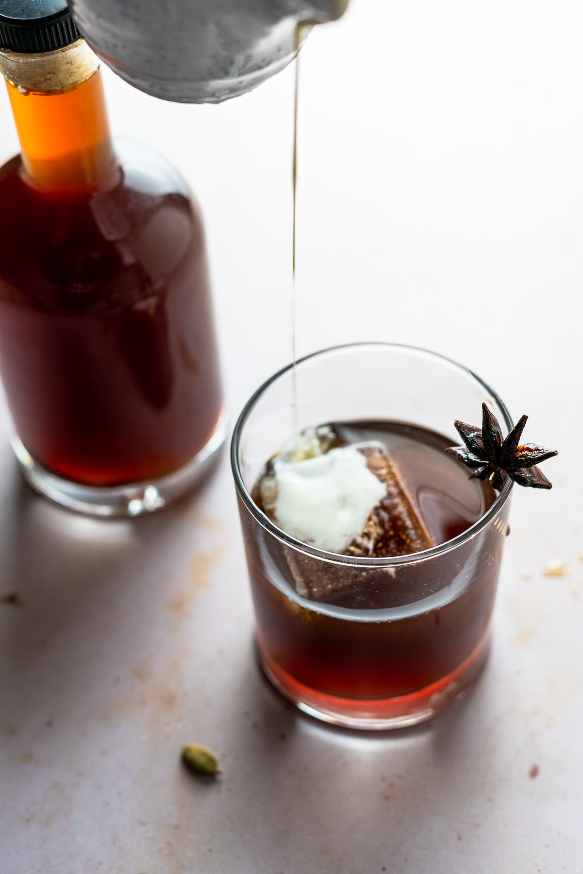 Chai Liqueur with alcohol bottle and heavy cream being poured in