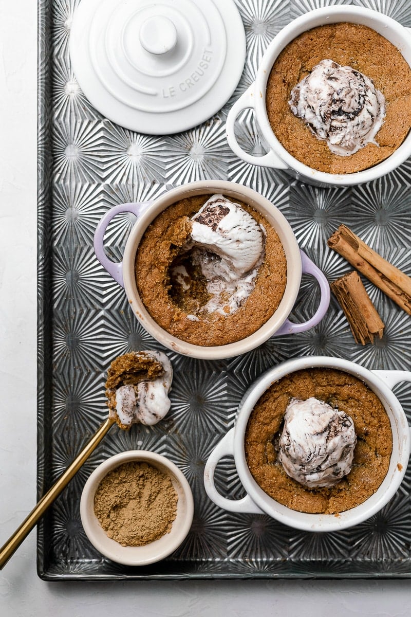 3 Deep Dish Gingersnap Cookies with Ice Cream in Le Creuset Cocottes with ginger powder and cinnamon sticks in ovenex sheet tray