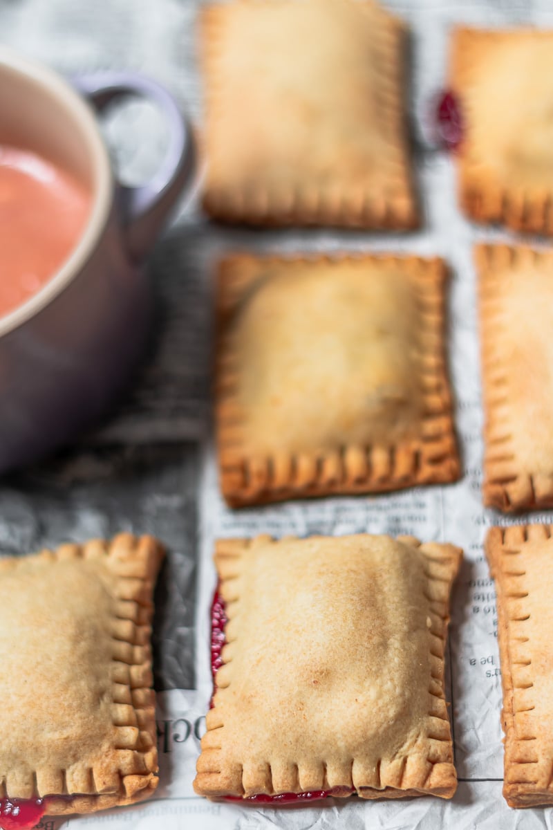 golden brown baked guava pop tarts on a piece of newspaper