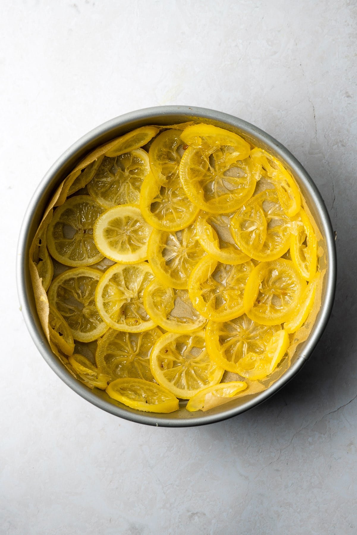 candied lemon slices layered in a springform pan