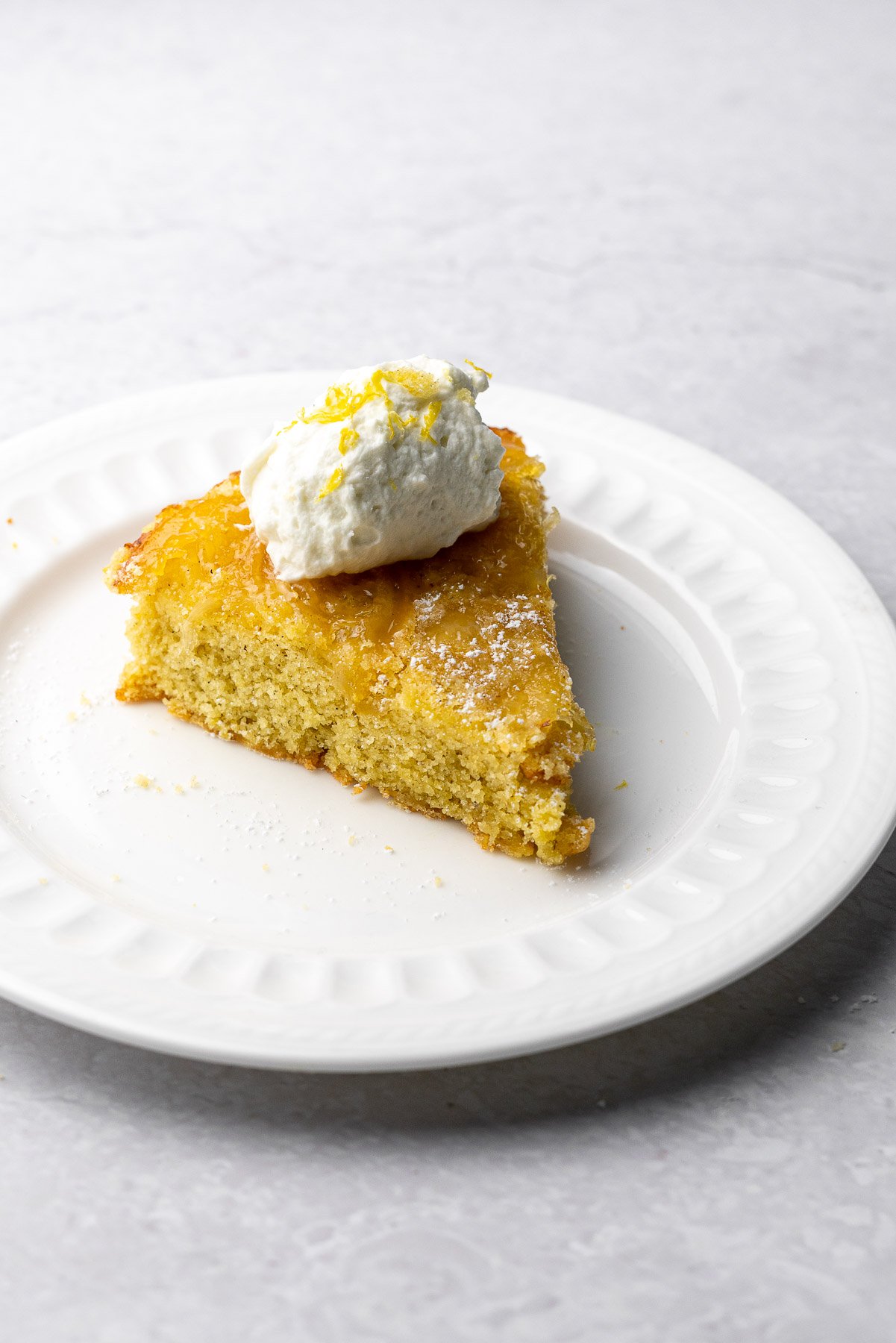 Single Slice Lemon Cardamom Olive Oil Cake on a plate