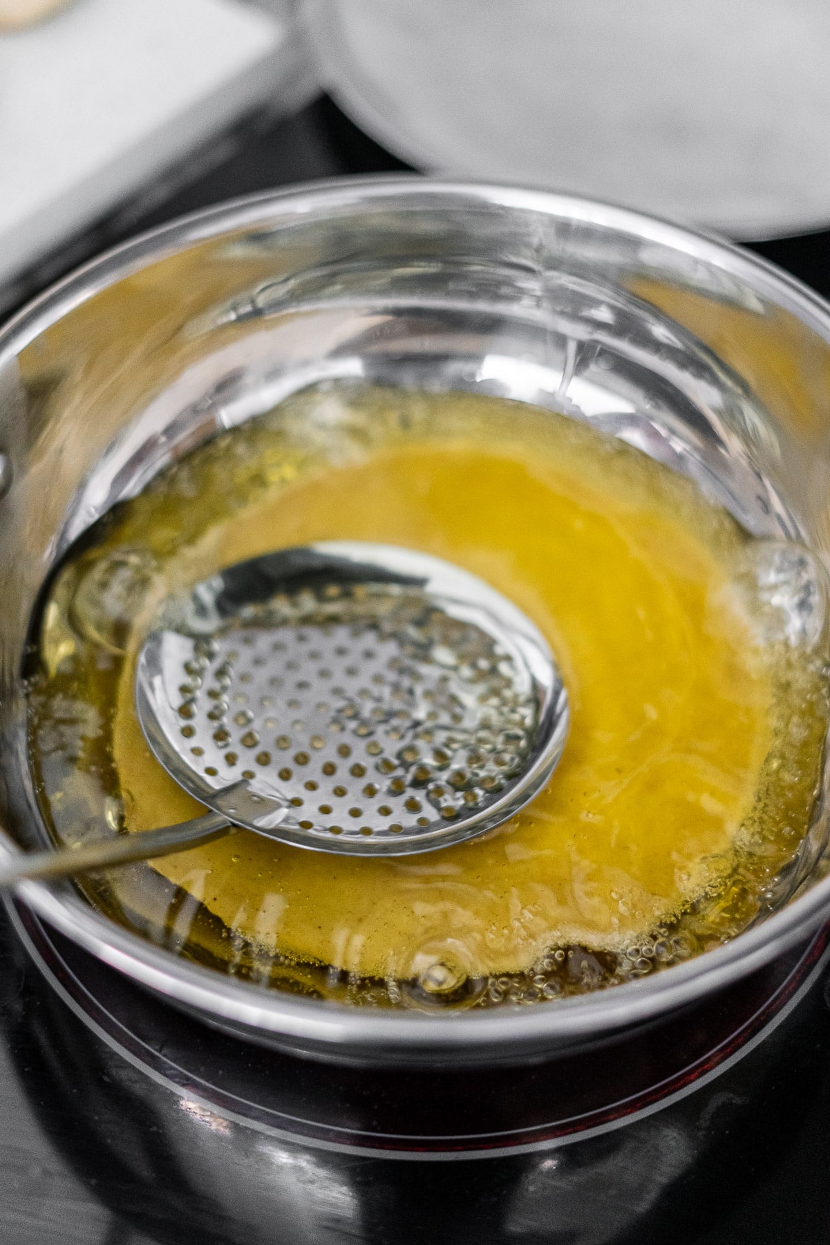 Bhatura dough being fried in oil