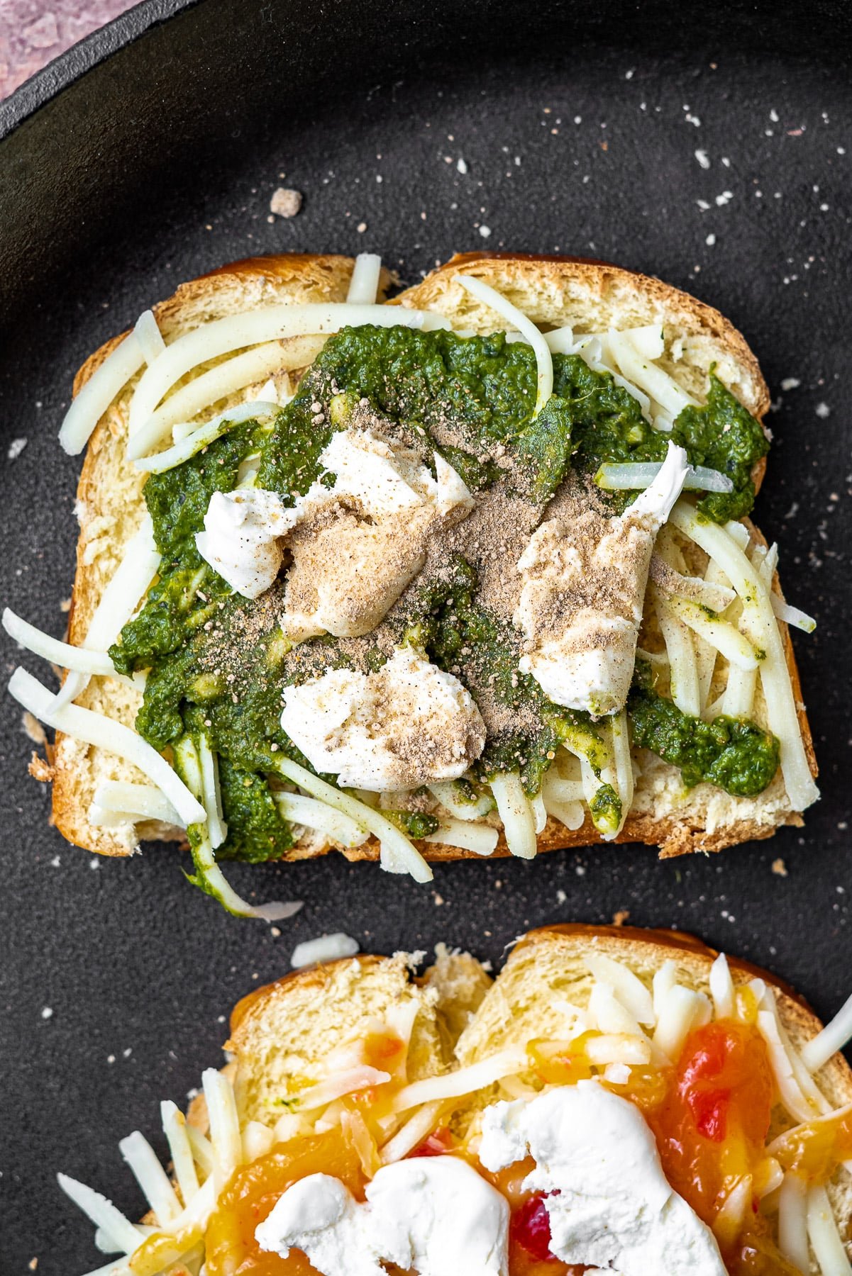 Sliced Bread topped with shredded mozzarella, cilantro mint chutney, chaat masala, and more mozzarella