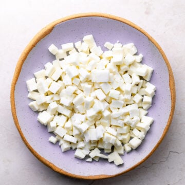 diced paneer on a purple bowl