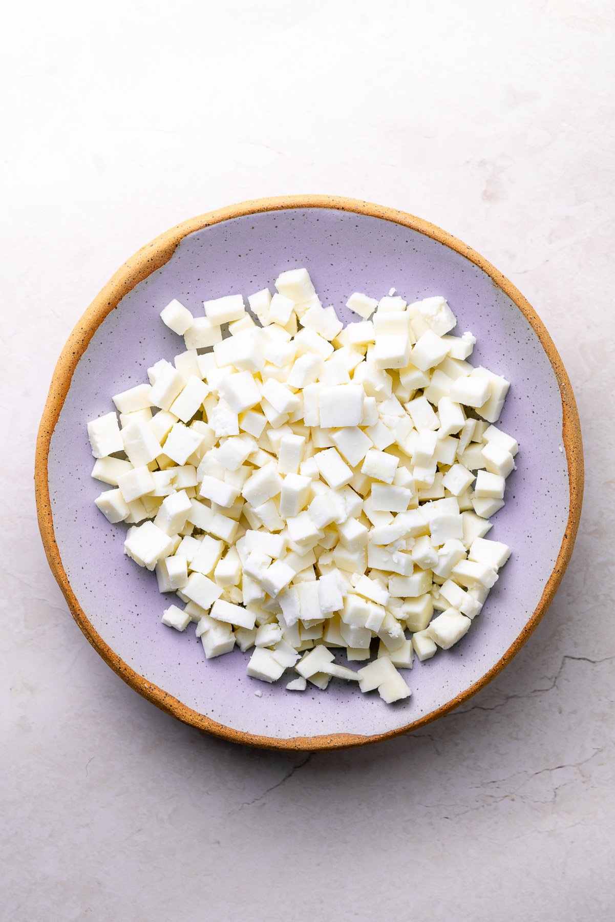 diced paneer on a purple bowl