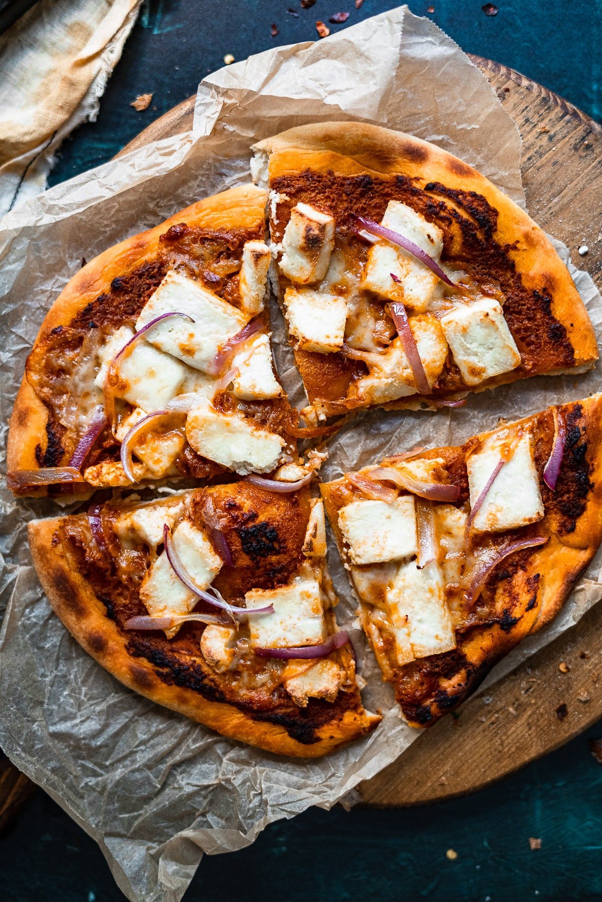 paneer makhani pizza on a wooden board