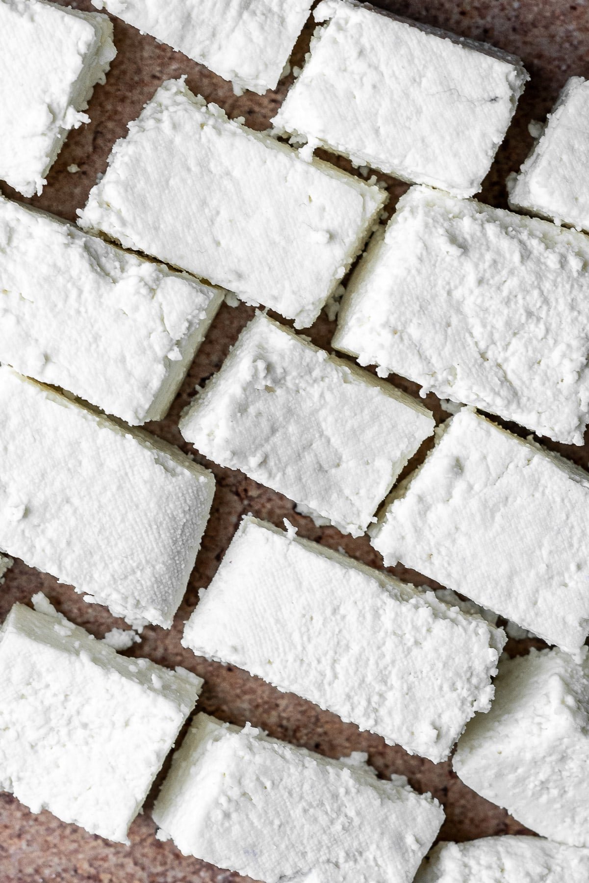 fresh pieces of homemade paneer in a diagonal line