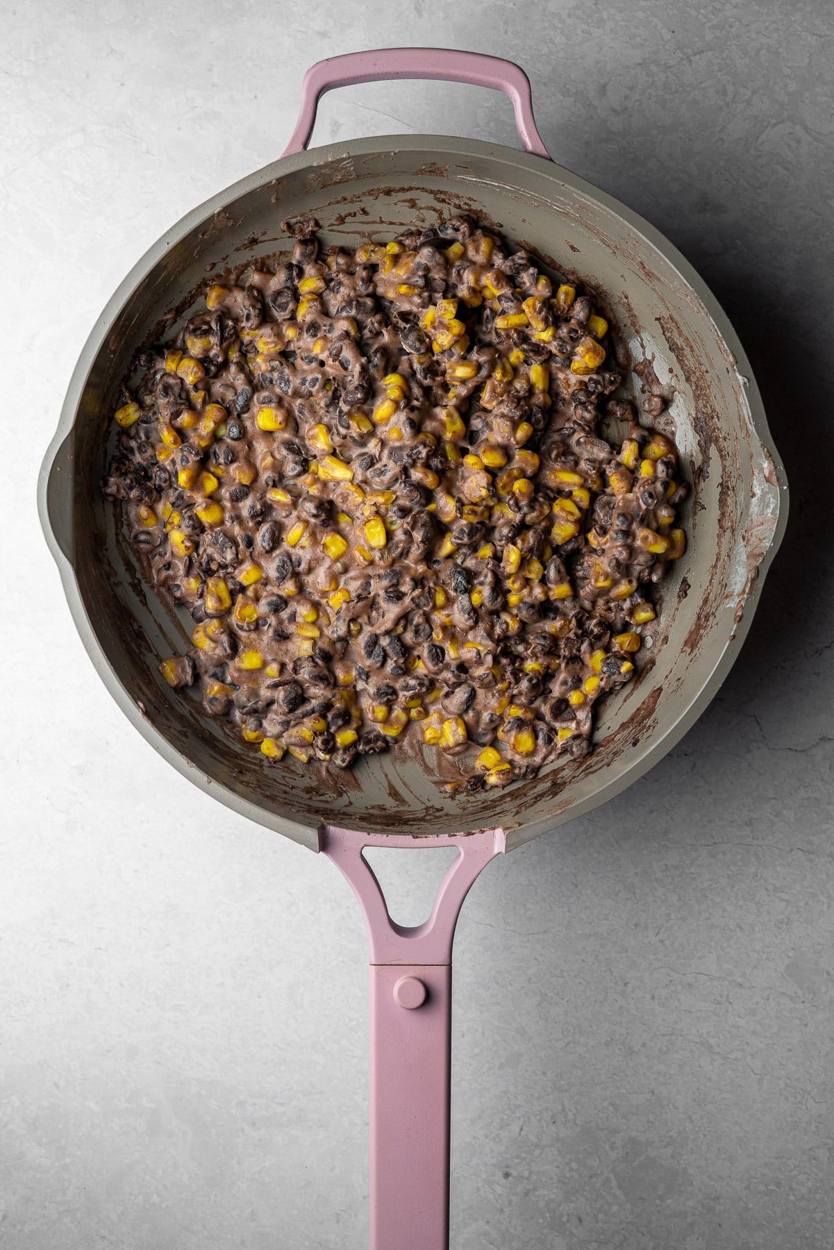 corn, black bean, and cream cheese filling in a purple always pan