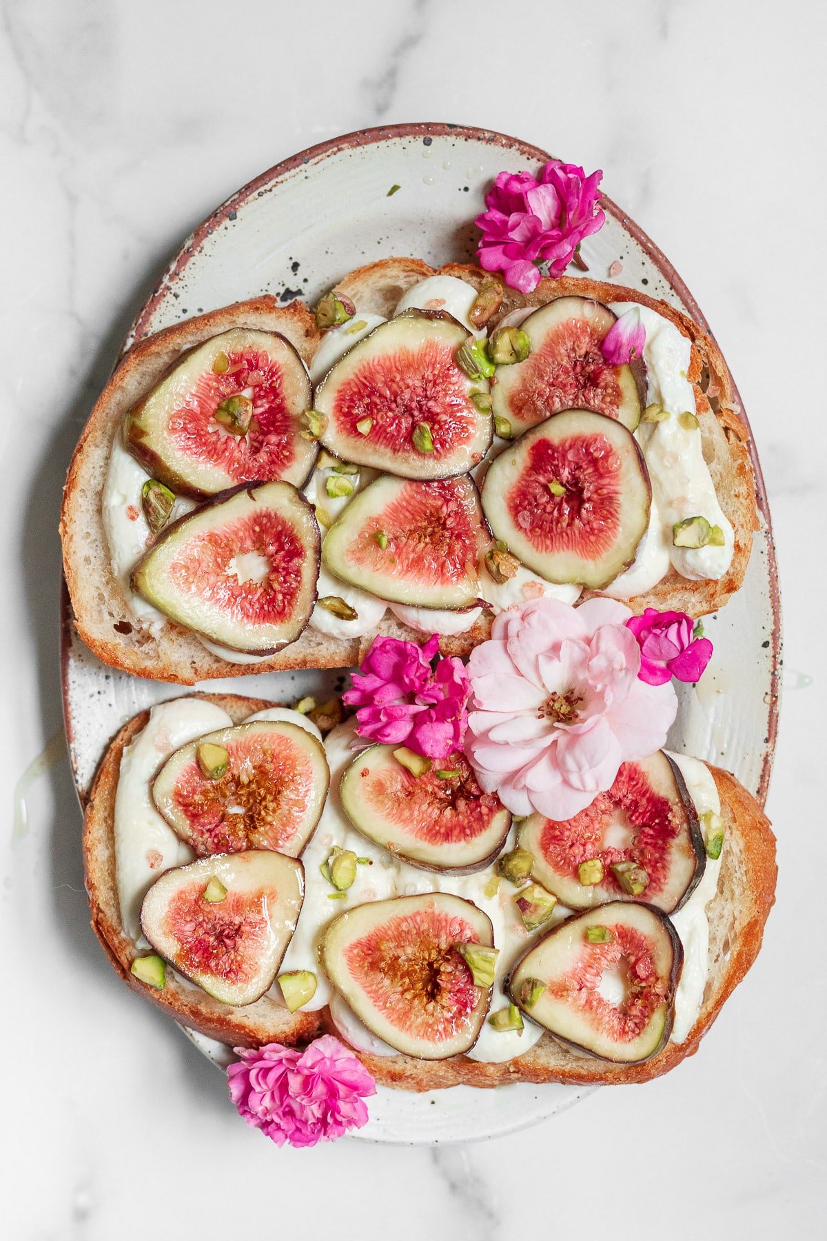 whipped honey ricotta toast with figs and pink flowers