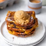 stacked chocolate stuffed brioche french toast with a dollop of coffee whipped cream on top