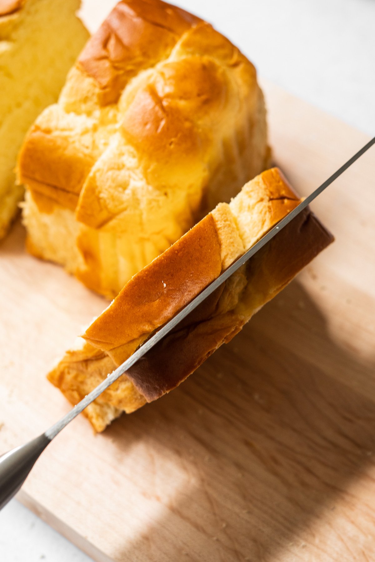 slicing a thick cut slice of brioche down the middle