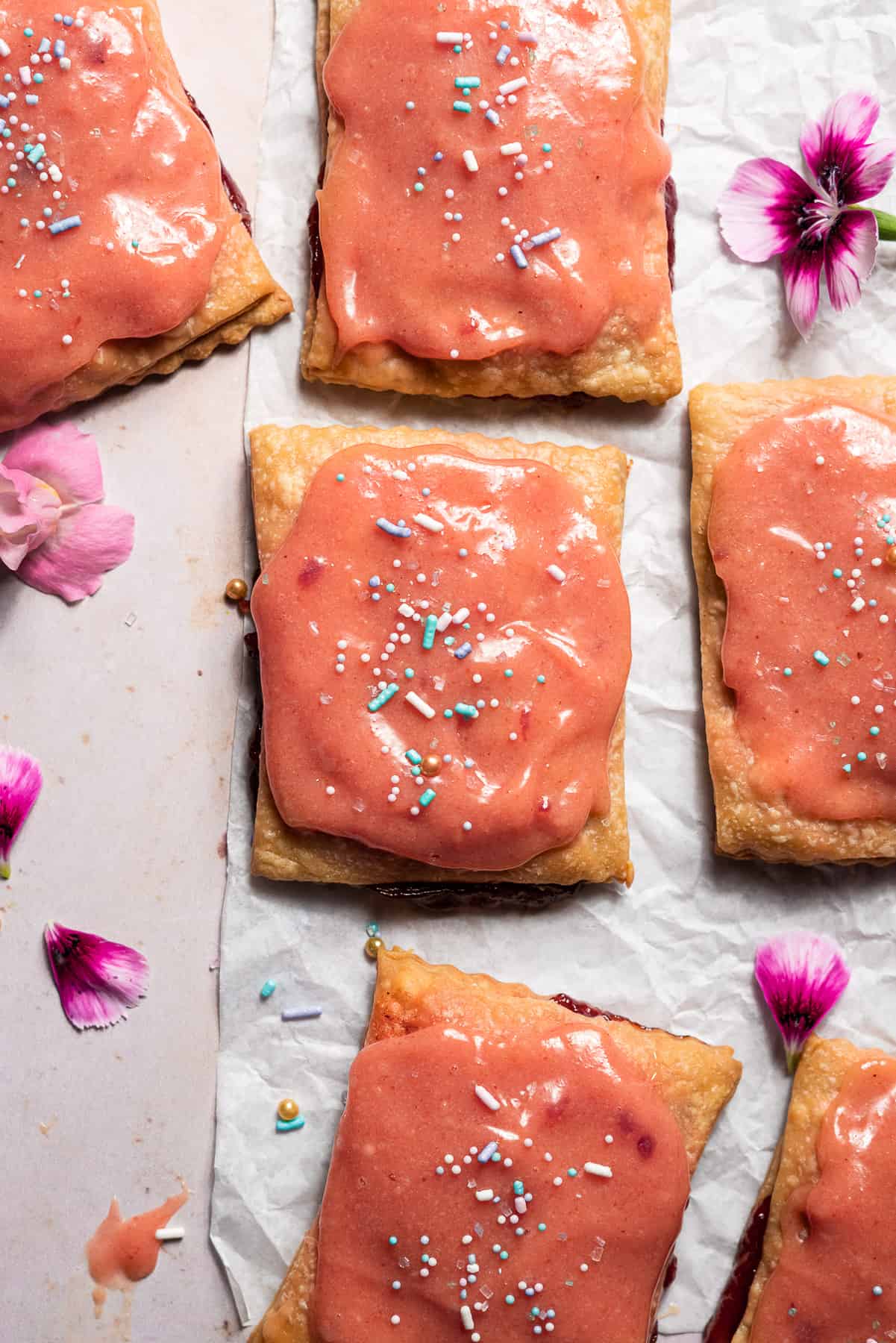 freshly glazed guava poptarts with sprinkles and edible flowers