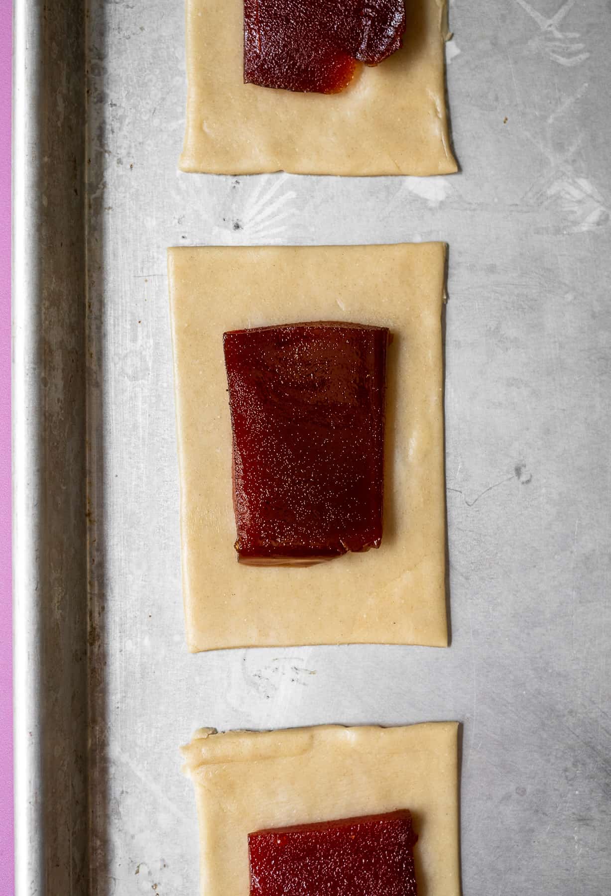 blocks of guava paste in rectangular cut outs of pie crust in a baking sheet