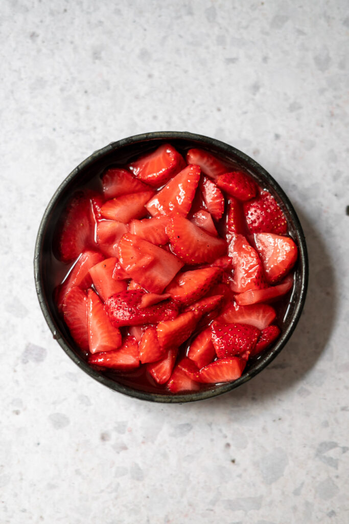 jammy strawberries cooked down in a black bowl