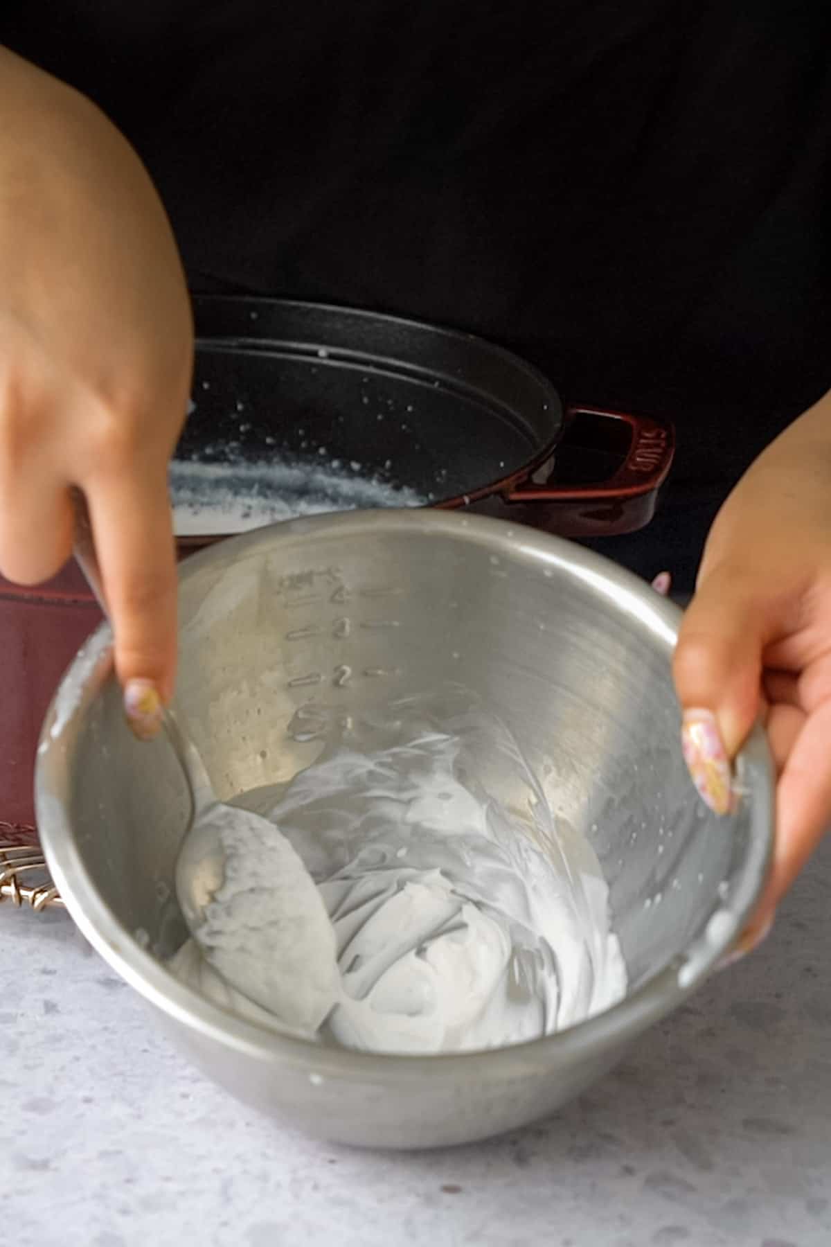 mixing the yogurt starter with a spoon in a bowl