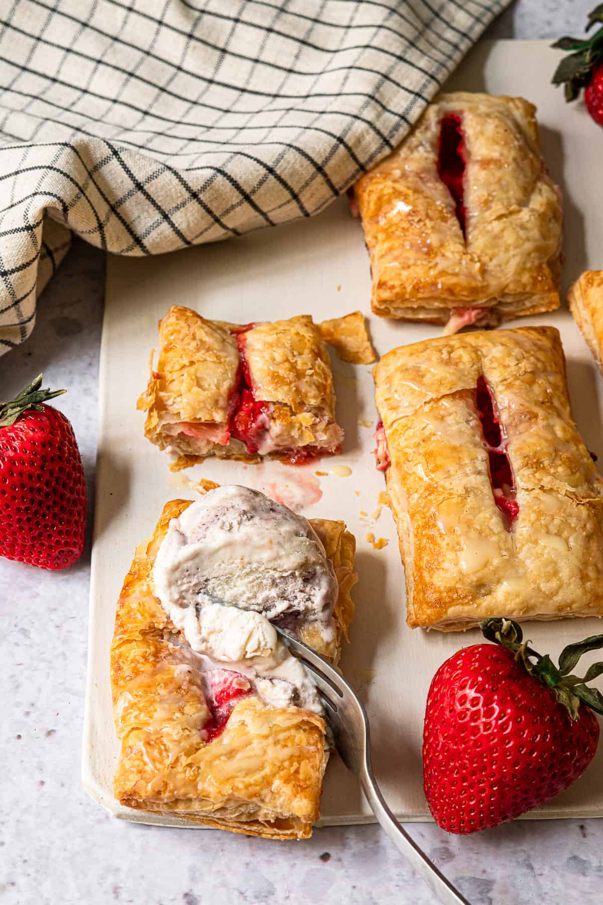 strawberry turnovers with a fork digging into a scoop of ice cream