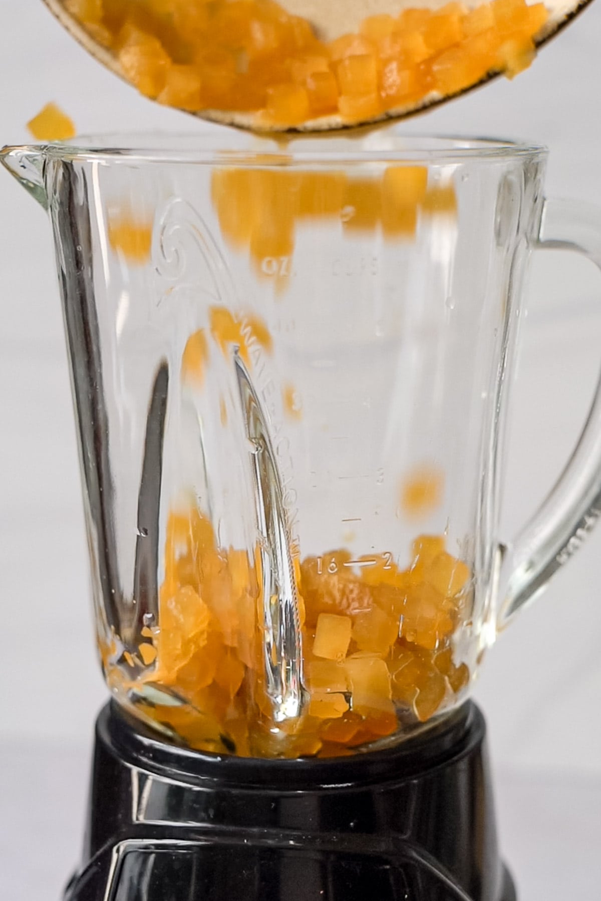 pouring apple cider ice cubes in a blender