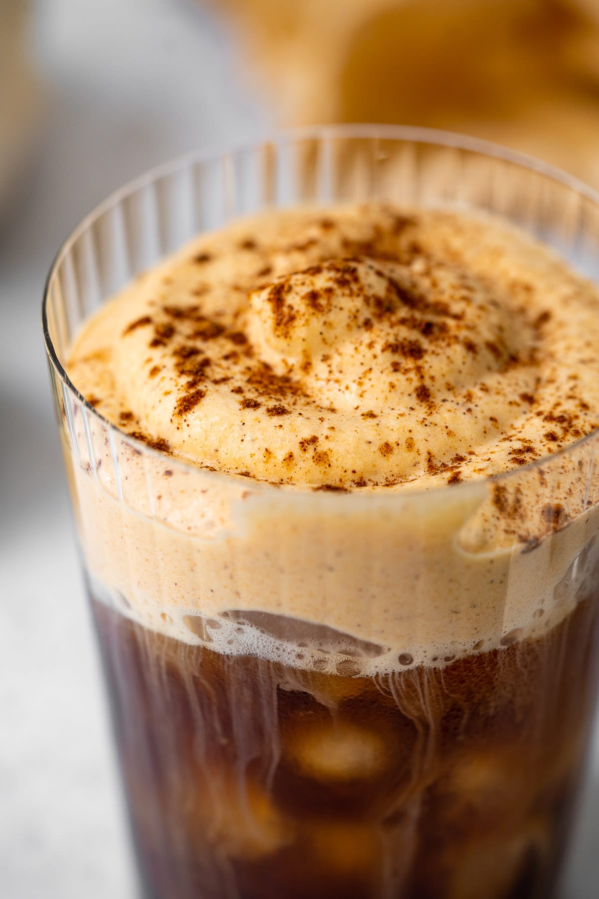 macro shot of pumpkin cream cold foam with pumpkin spice