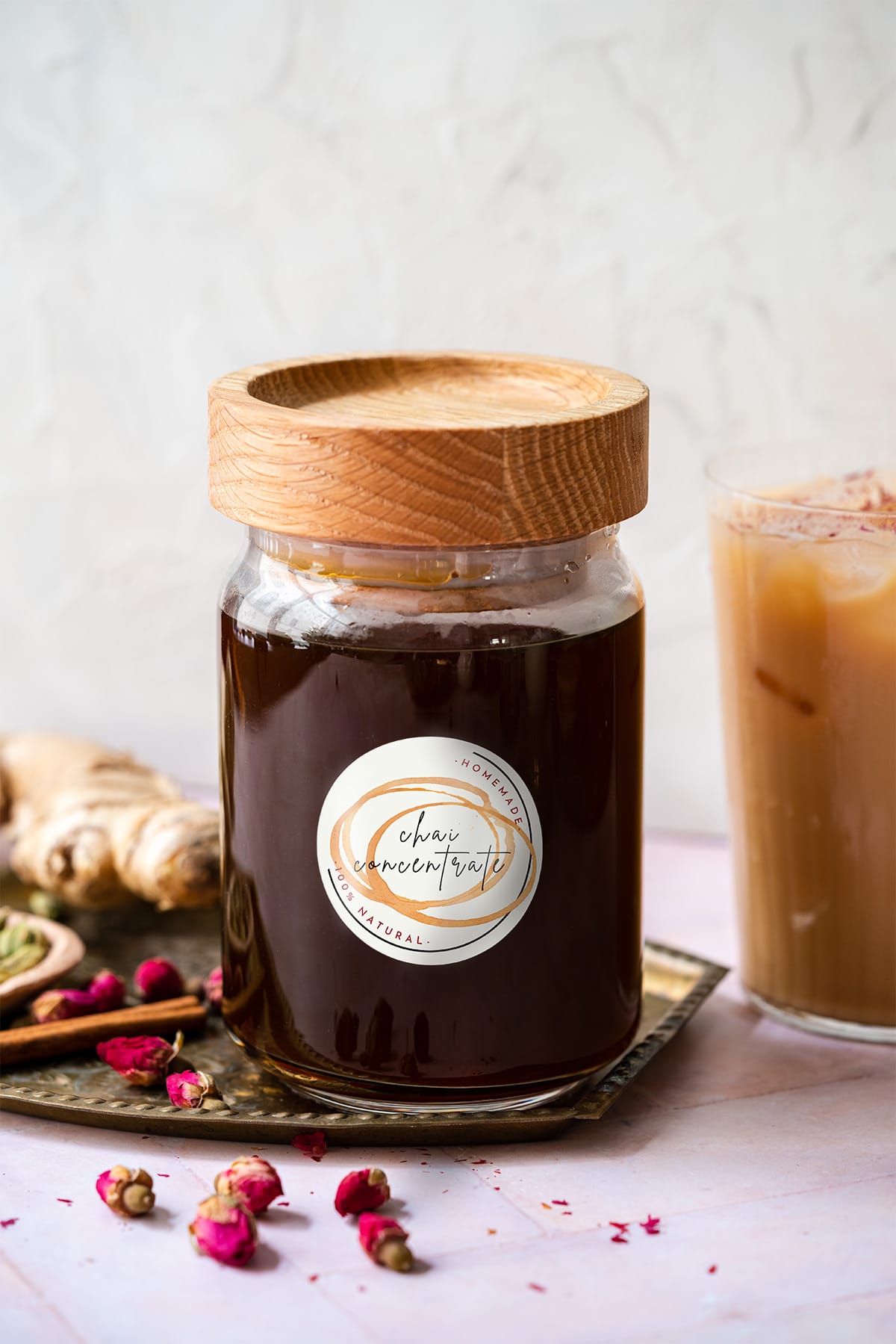 bottle of chai concentrate with a wood lid on a brass platter