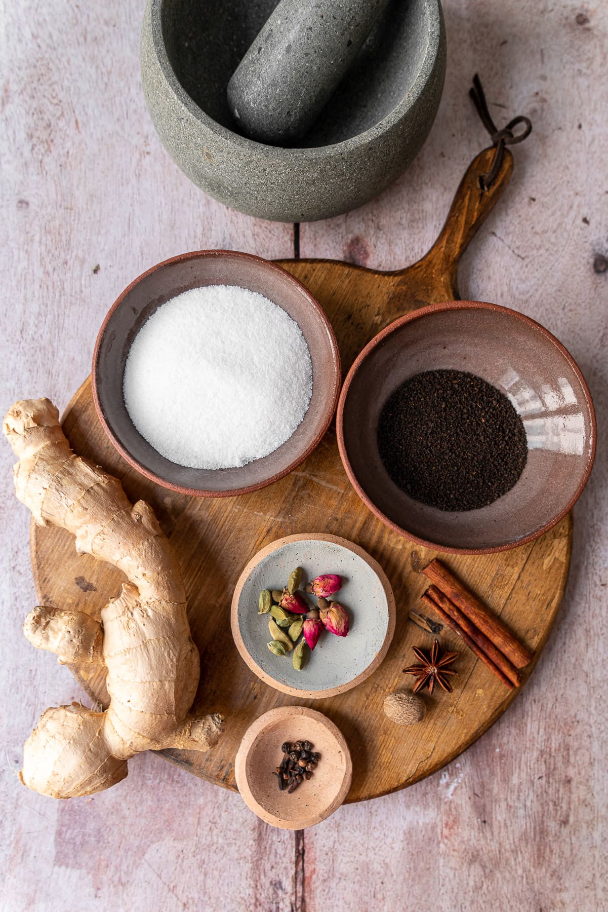 chai ingredients on a wooden bread board