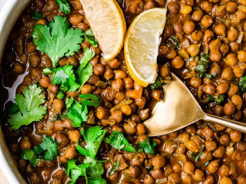 kala chana masala in a serving bowl with a gold serving spoon