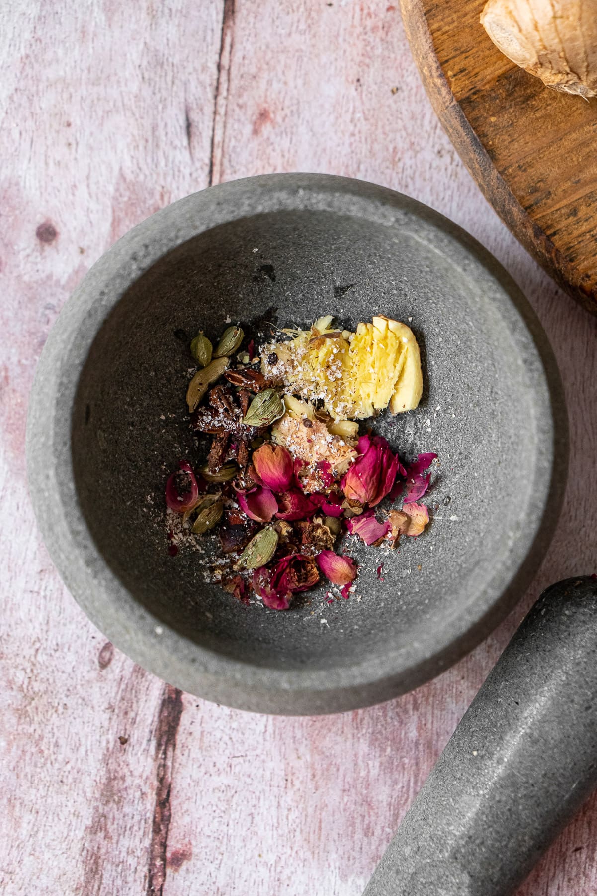 smashed chai spices in a mortar and pestle