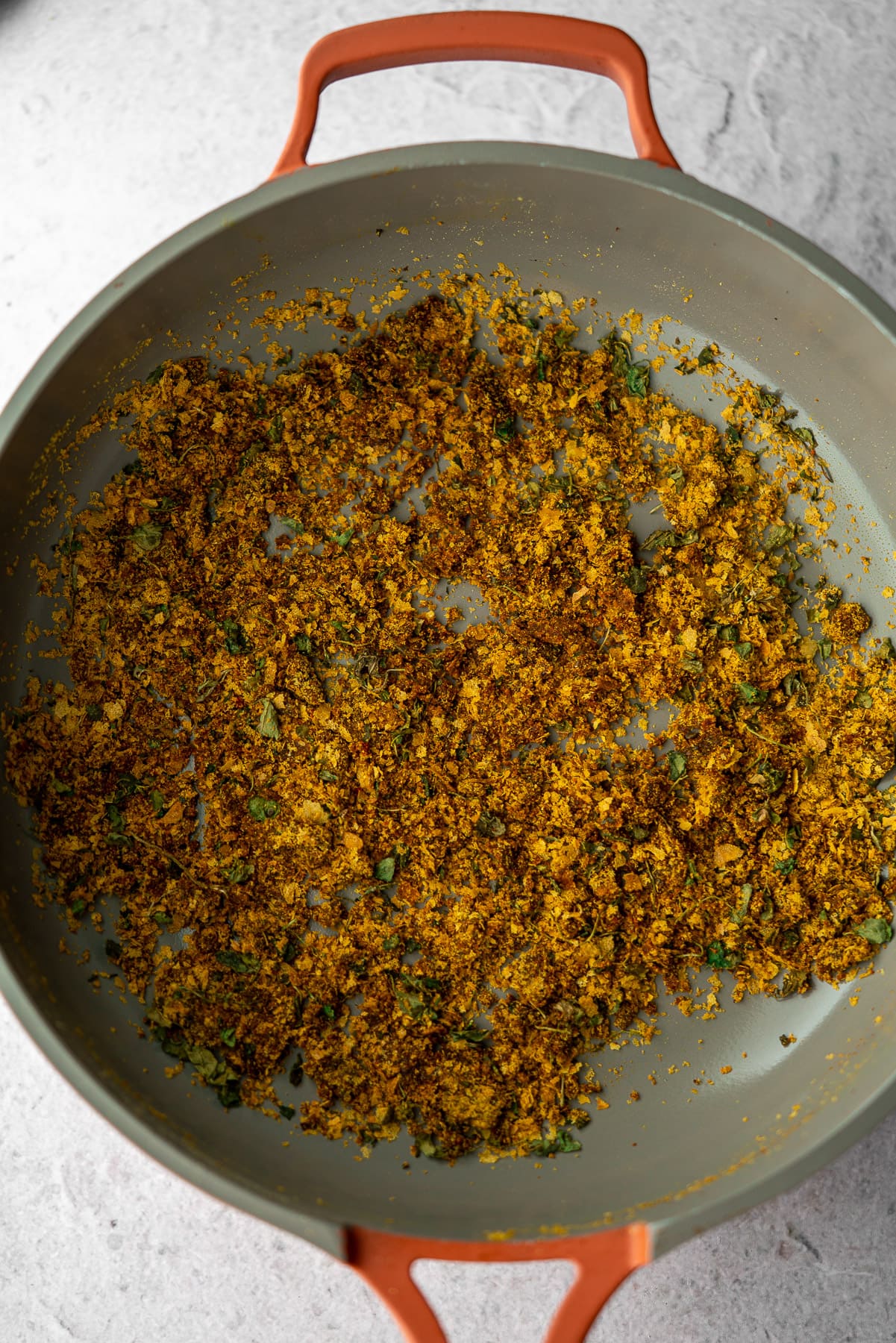 bloomed spices and nutritional yeast in a pan