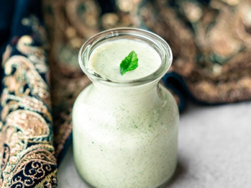 curry leaf ranch in a jar with a fresh curry leaf with a dupatta cozying into it