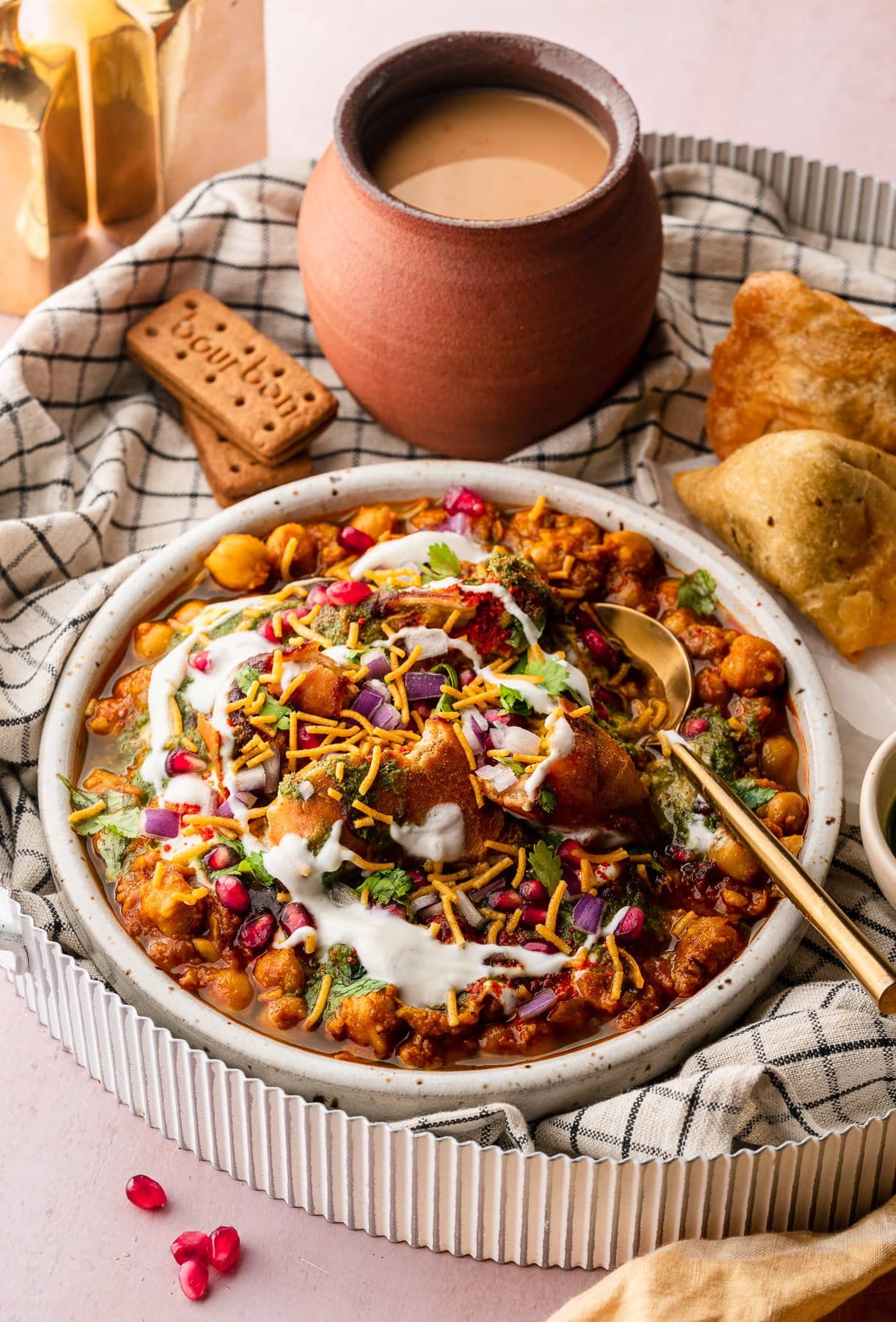 samosa chaat with in a tray with masala chai and extra samosa with chutneys