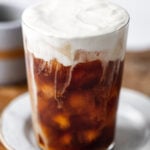 sweet cream cold foam cold brew in a glass on a plate