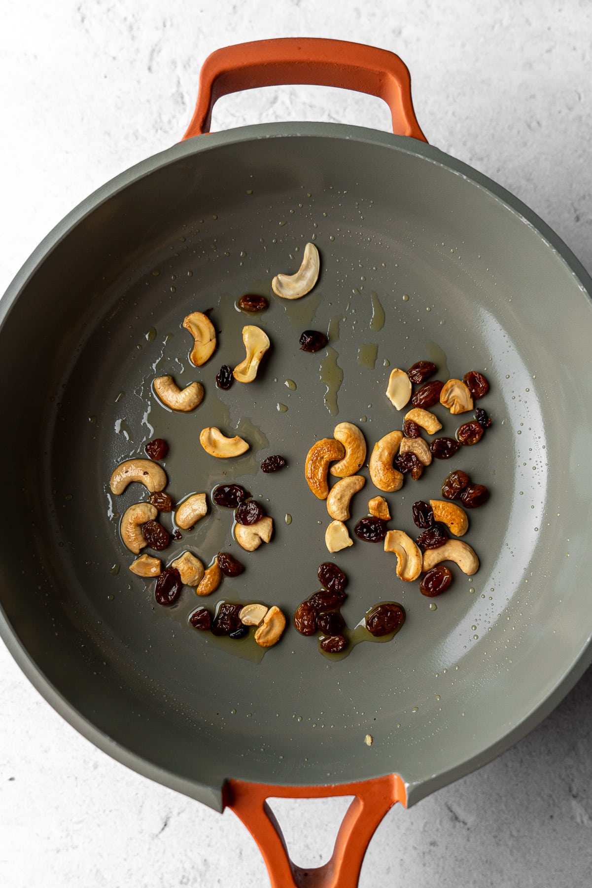 toasted cashews and golden raisins in a pan