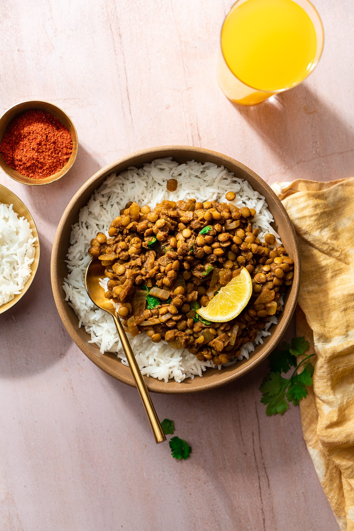 whole masoor dal in a bowl with rice and a gold spoon