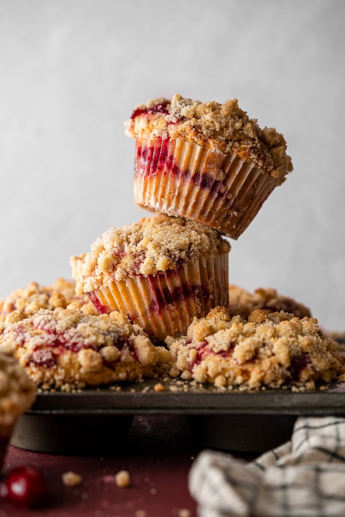 stack of cranberry sauce coffee cake muffins in a muffin pan