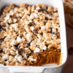 sweet potato casserole in a white baker with toasted marshmallow