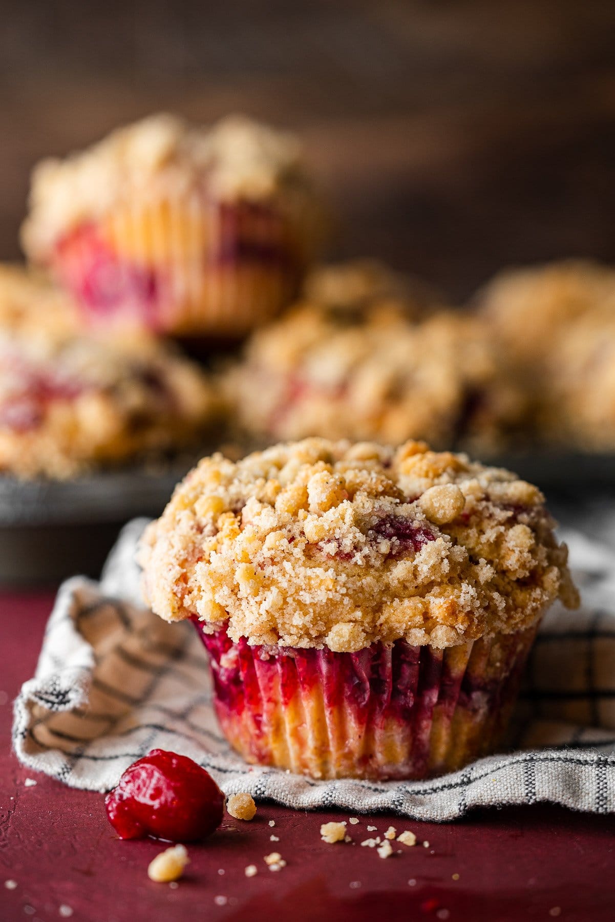 leftover cranberry sauce muffin on a tea towel with a bundle in the back