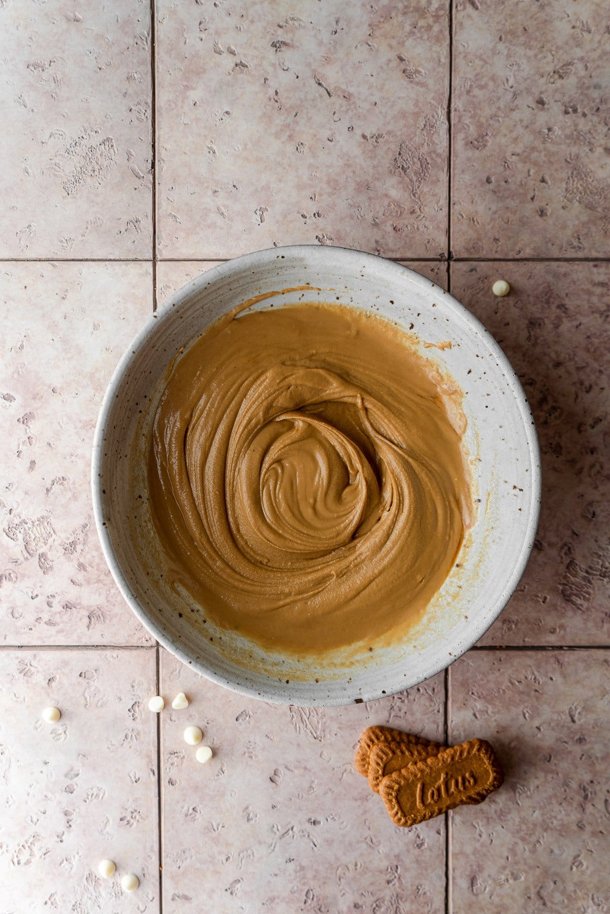 bowl with mixed cookie butter white chocolate ganache with lotus cookies below