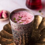 rose lassi in a vintage lassi glass in a brass tray