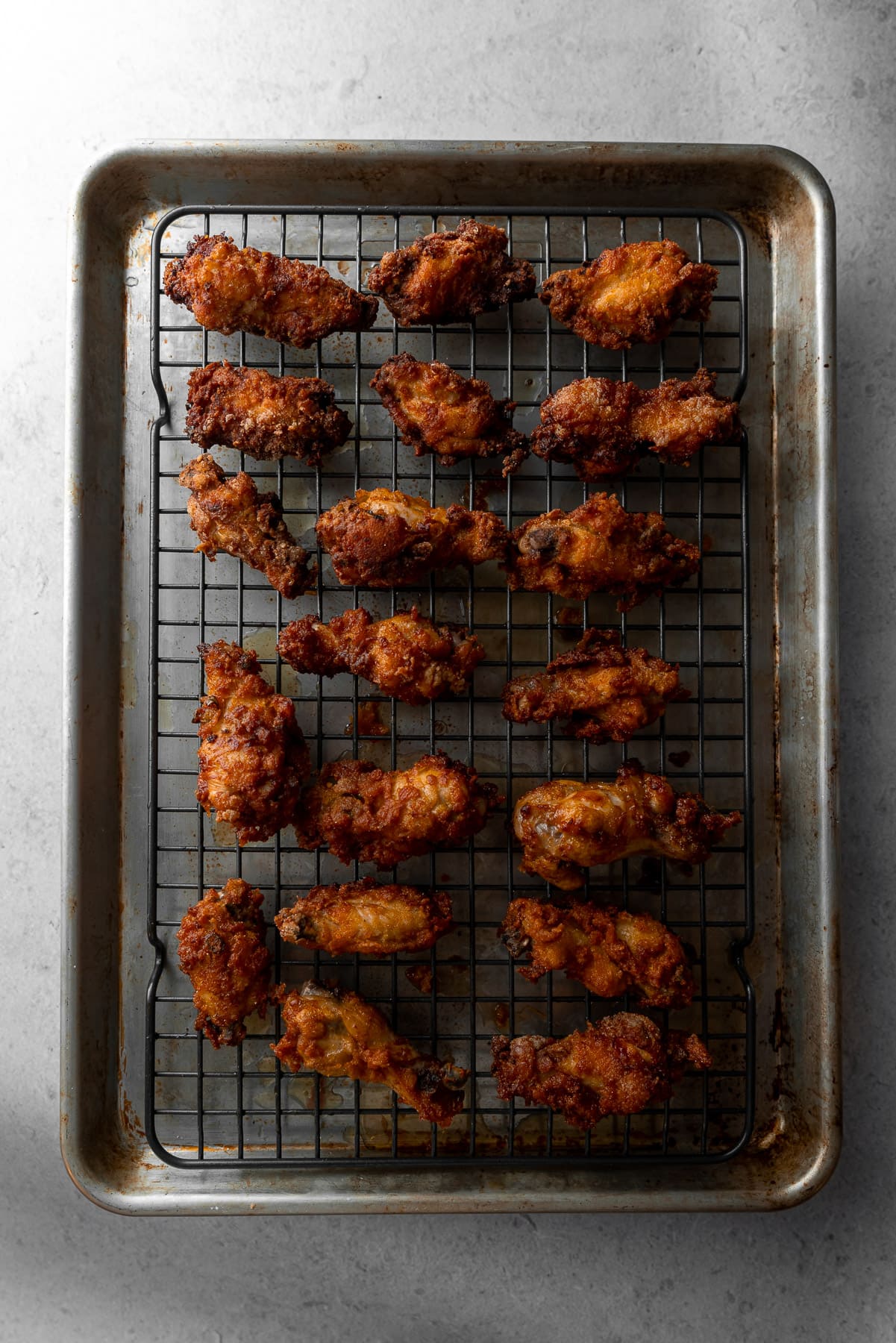 fried butter chicken wings on a cooling rack