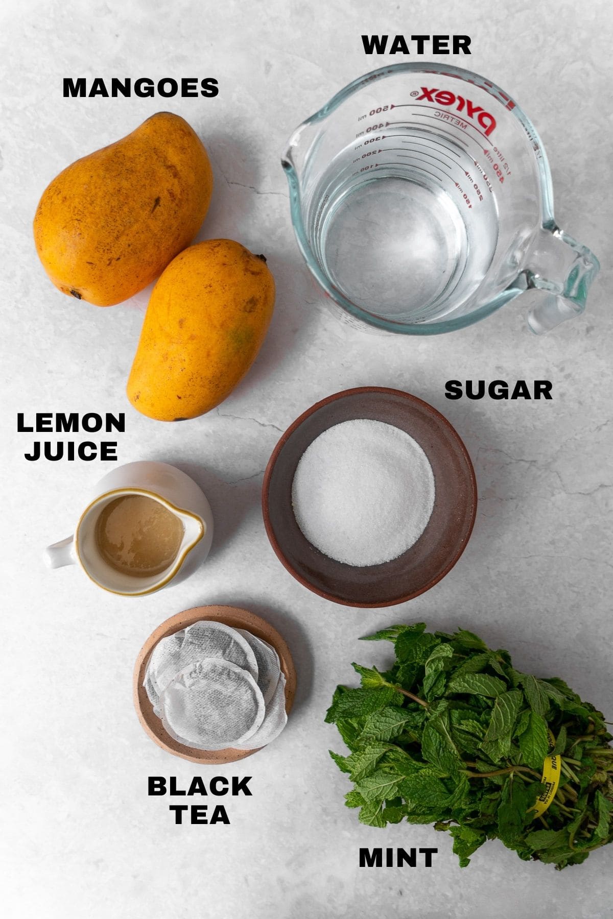 flatlay of ingredients for mango iced tea with labels.