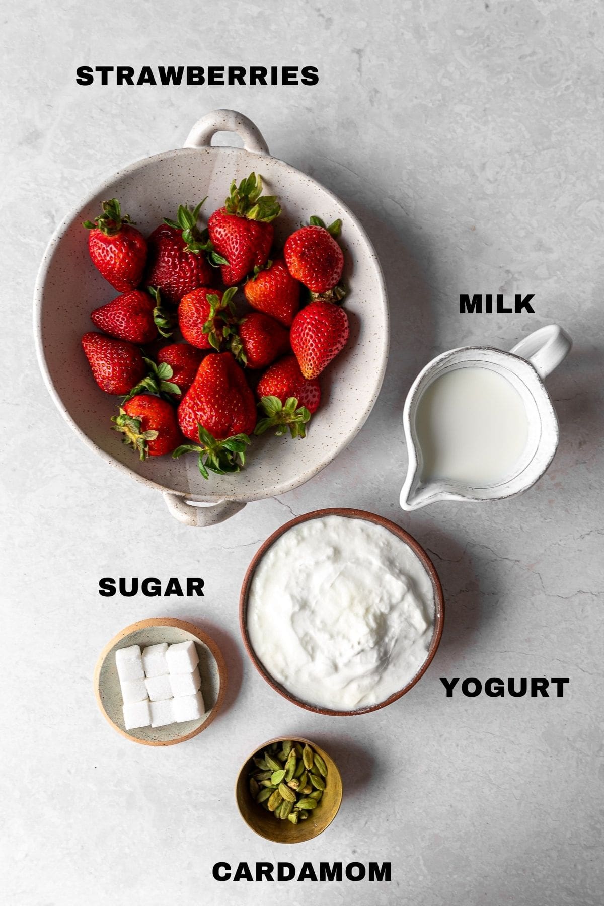 Ingredients for strawberry lassi with labels.