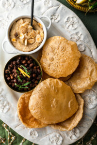 Halwa, puris, and chana in a decorative platter.