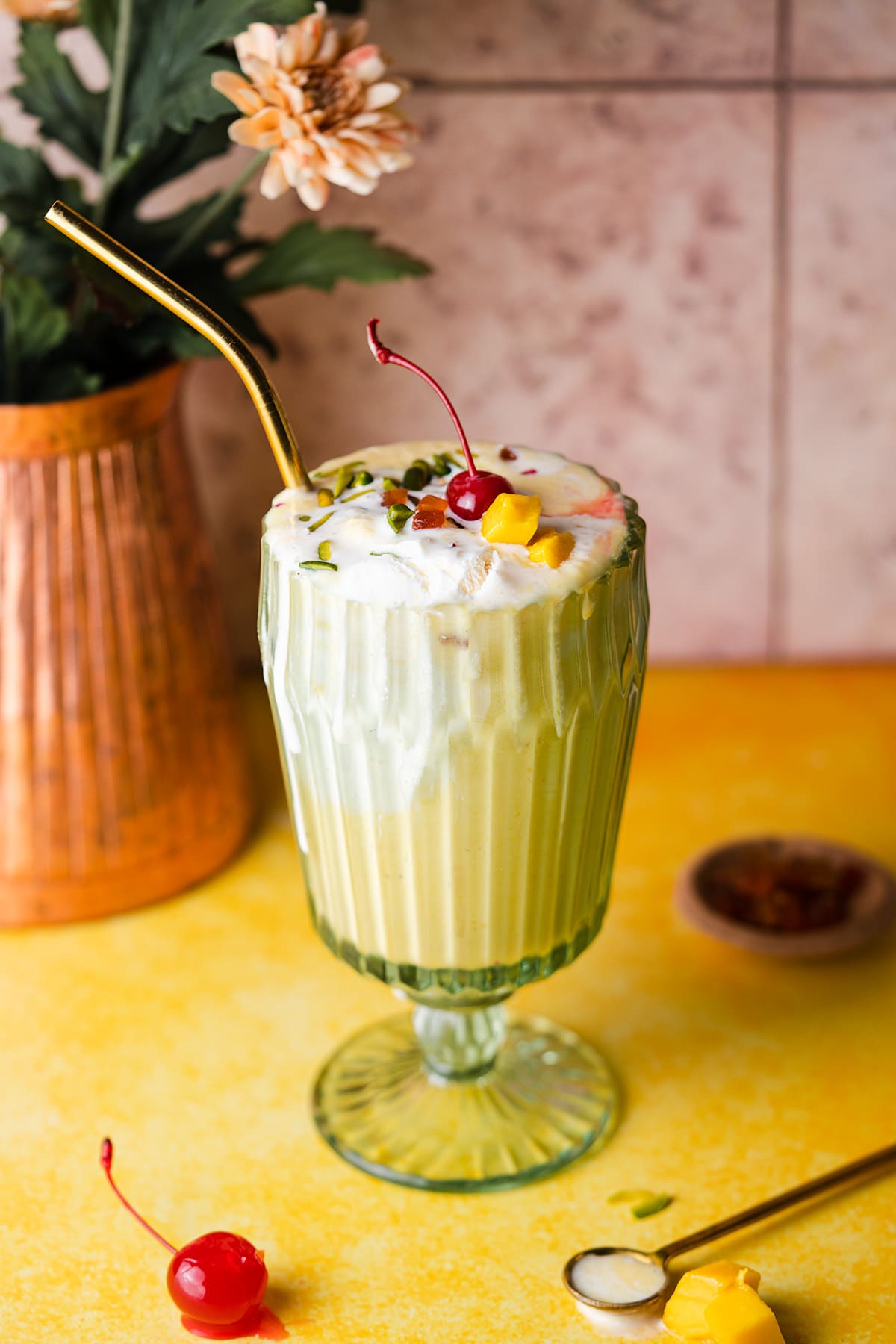 Mango Milkshake in a vintage cup with a copper vase in the back.