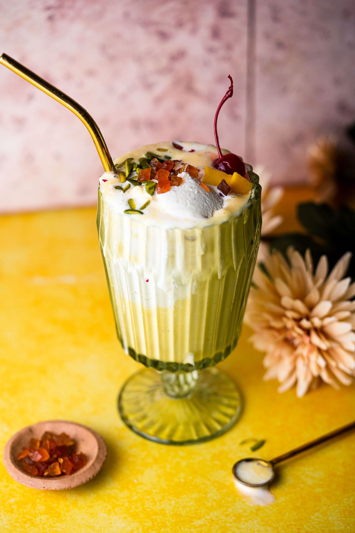 Mango Milkshake in a vintage cup with a gold straw.